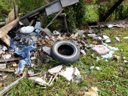 Large litter items on roadside.