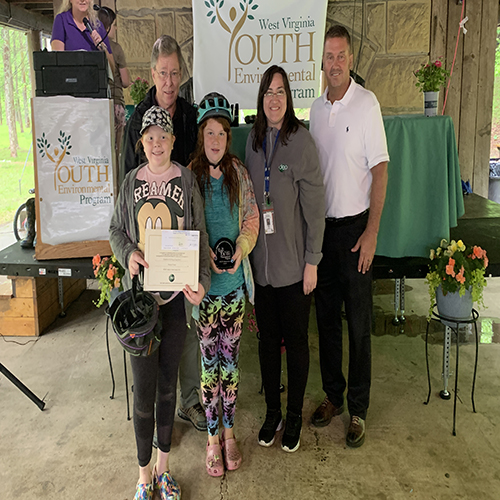 Ed Maguire, Niki Davis and Erik Sims presenting the REAP Adopt-A-Spot Award to winner Girl Scout Troop 38217 out of Braxton County.