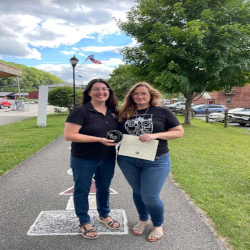 A member of the Deer Creek Defenders 4-H club poses for a photo with Beth Henry-Vance from the DEP's Youth Environmental Program.