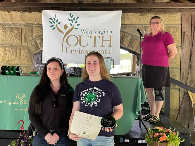 A member of the Arvilla Wide Awakes 4-H club poses for a photo with Brooke Hinzman of the DEP's Youth Environmental Program.